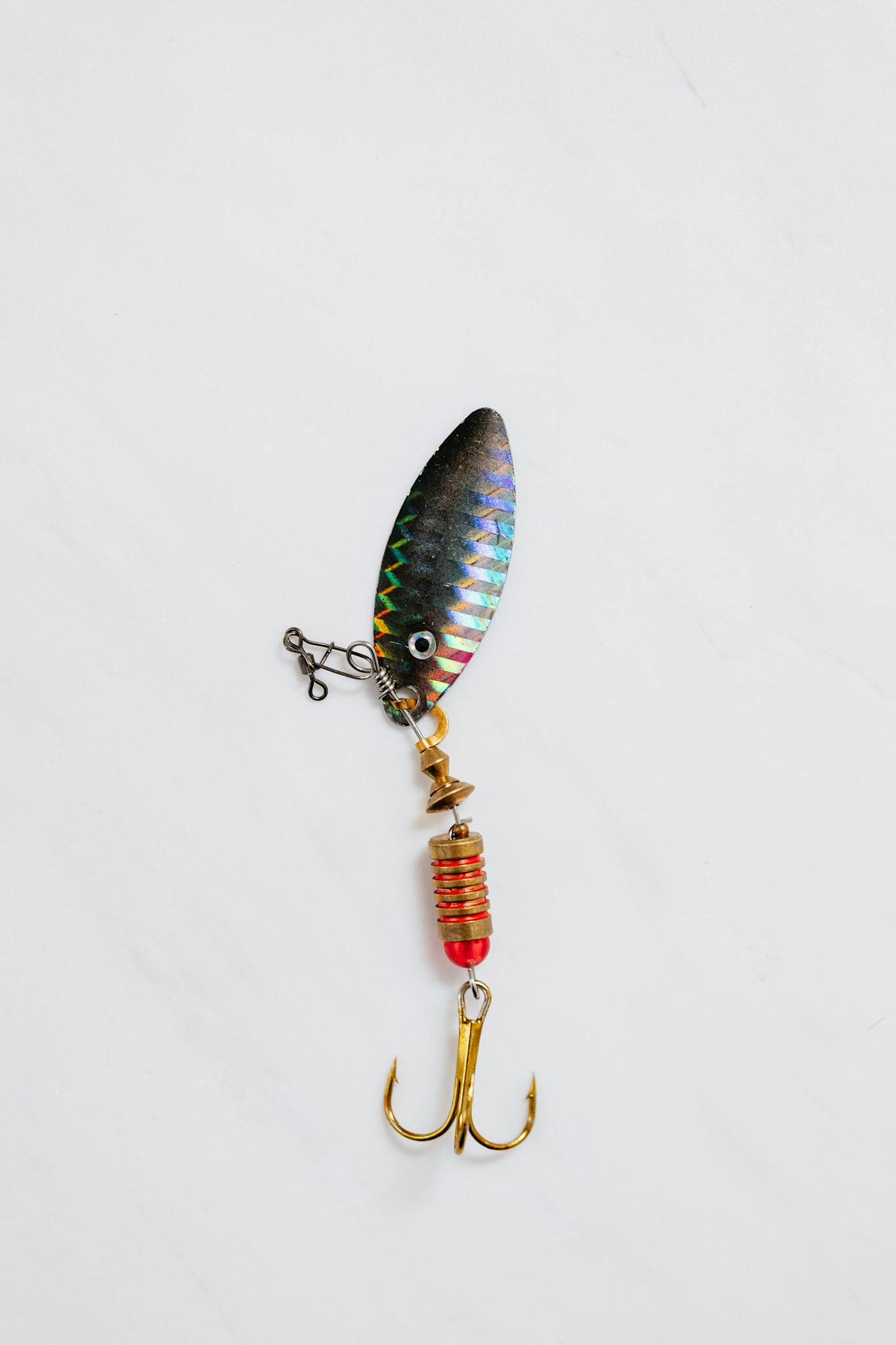 Vibrant fishing lure with hooks displayed on a clean white background.