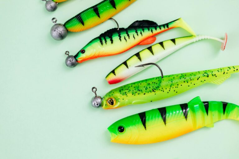 Vibrant fishing lures on green background, ideal for angling enthusiasts.